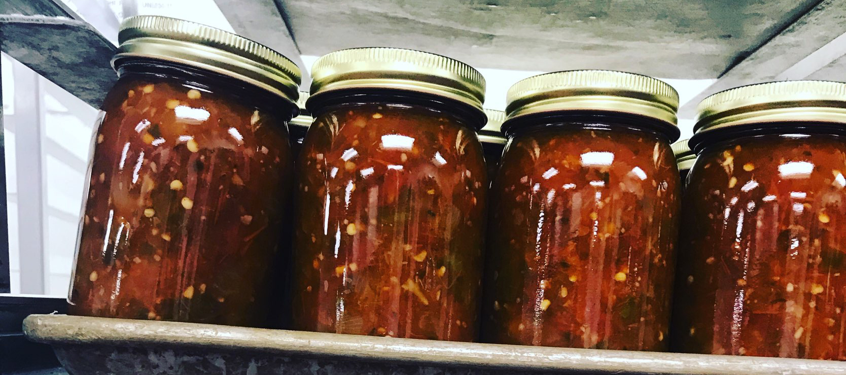 Tomato sauce in jars on a shelf